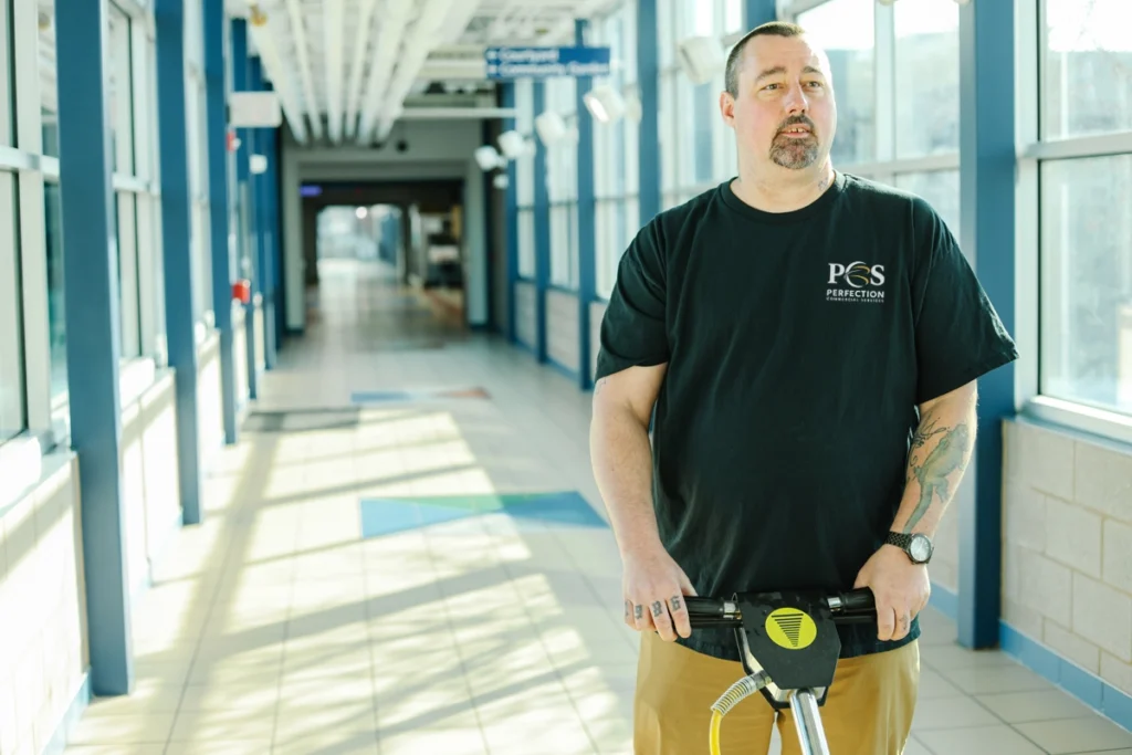 Perfection Commercial Services Team Member cleaning hallway